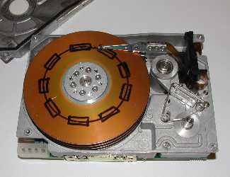 A hard disk, opened and with the arm and platters exposed